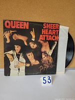 Front cover of Queen Sheer Heart Attack vinyl LP showing band members and album title in red letters.
