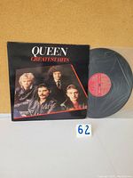 Front cover of Queen Greatest Hits vinyl album showing band members and title.
