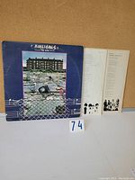 Front of gatefold cover showing title 'Hooligans' and album artwork with urban scene.