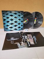 Trifold cover and two vinyl discs with booklet laid out