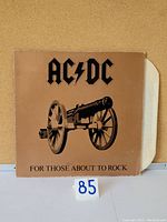 Front view of the gatefold cover of AC/DC vinyl LP 'For Those About to Rock' showing cannon image and text.