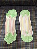 Two ceramic serving dishes side by side on plaid background; celery dish on right, rhubarb dish on left