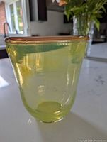 Photo of yellow blown glass vase showcasing ombre rim and rounded body
