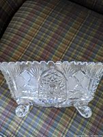 Top angled view of the rectangular footed crystal bowl showing cut crystal facets, star-like patterns, and four rounded feet.