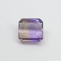 Front view of the rectangular ametrine gemstone showing the purple-yellow coloration and faceting.