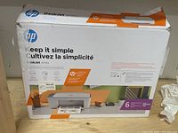 Front view of HP DeskJet 2755e printer box showing product design and condition with some wear and tape.