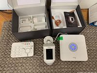 Full view of keypad, base station, camera, and sensor boxes on floor