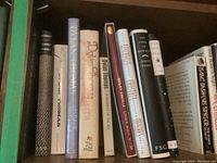 Books on shelf showing multiple titles from Dylan Thomas, including narrative and poetry works.