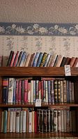 Bookshelves filled with various hardcover and softcover books showing spines with titles and authors including Robert Crais.