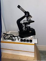 Microscope, lenses, power cord, instruction sheet in original styrofoam packaging