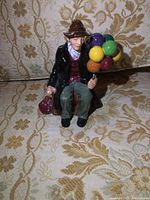 Front view of porcelain Balloon Man figurine showing colorful balloons and detailed clothing.
