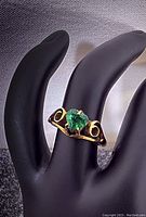 Ring displayed on black mannequin showing front view