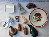 Overview of all 11 vintage items arranged on cloth with measuring tape around indicating size