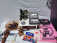 Photo displaying the majority of vintage and retro items including figurines, photographs, cups, advertising materials, and boxed 3D lamp