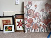 Six pieces of floral artwork grouped together, showing various sizes and frame styles, mostly floral images in warm tones.