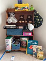 Wide view of toys, games and books on solid maple shelf