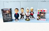Photo showing the complete lot with five bobbleheads and one boxed Funko Pop.