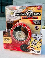 Front view of the unopened Kansas City Railroad Pocket Watch packaging showing the watch, branding, and key features including the chain and fob.