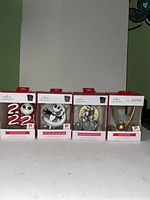 Front view of all four boxed Hallmark ornaments showing Jack Skellington, Zero, Sally, and Harry Potter Golden Snitch.