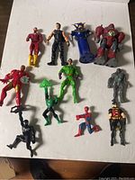 Full view of 11 assorted action figures on white background