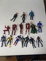 Full group of 16 assorted 3 3/4 inch action figures including superheroes in various poses and colors.