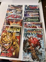 All 10 DC Comics comics laid out in a white box showing various superhero titles including The Flash, Green Lantern, Aquaman, Injustice, New Guardians, and Savage Hawkman.