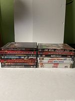 Front view of two stacks of DVDs showing spines, titles visible and some partially visible.