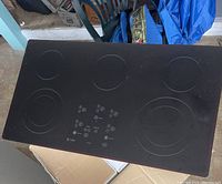 Top view of the GE Profile electric stove top showing five burners and touch control panel.