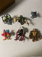 Top view of the seven toy figures arranged on a white surface