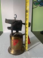 Side front angle showing the full blow torch with measuring tape indicating approximate height of 10 inches; brass fuel tank with Clayton & Lambert label visible