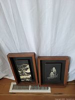 Two framed lithographs standing side by side on a floor vent with white backdrop, showing overall lot contents.