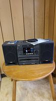 Front view of AIWA NSX-800 stereo system with two detachable speakers, manual and antenna placed on top.