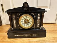 Full frontal view of clock on hardwood floor