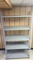 Full front view of the grey metal utility shelf unit with 5 shelves showing overall condition and structure