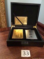 Full view of black executive case holding two decks of playing cards and certificate inside.