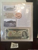 Photo of the Canadian $1 Scenes of Canada banknote with a Canadian penny and informational sheet.