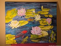 Full view of an acrylic painting showing water lilies, lily pads, and three koi fish swimming in a pond. Artist's signature visible on bottom right.