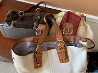 Four assorted purses showing styles and colors