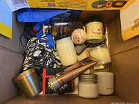 Box with assorted candles, bath balls, Vanilla Maple Moisture hand cream, and cables