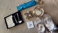 Overview of Birks sterling silver items on carpet: footed bowl, shakers, trays, napkin ring, boxed spoons and ladle