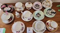 Overhead shot of all tea cups, saucers, and bell arranged on table