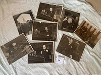 Overview of all eight photographs laid out on a carpeted surface, showing Churchill in different poses and settings.