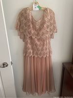 Front view of vintage dusty pink dress with scalloped lace overlay and chiffon slip skirt.