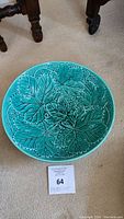Full view of the round bowl showing intricate green leaf design inside.