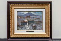 Full view of framed painting showing seascape with boats and mountain background.