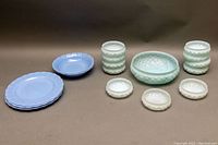 Full lot with four blue Pyrex plates, milk glass fluted bowls and dishes, and a large light green depression glass salad bowl.