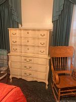 Front view of the two-tiered dresser showing drawer fronts, handles, and shape.