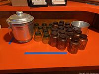 Overview photo of all glassware and ice buckets arranged on an orange surface.