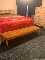 Bench placed at foot of bed in bedroom setting showing full length and style.