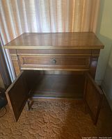 Front view of the nightstand with drawer open and cabinet doors open, showing wood veneer and hardware